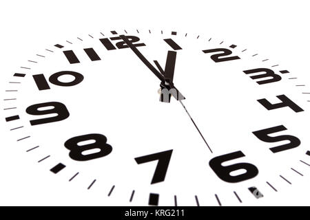 Clock isolated on white marking the one o'clock hour. The main focus is in the hour hand. Stock Photo