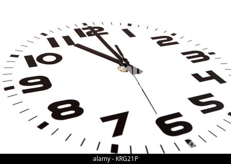 Clock isolated on white marking the eleven o'clock hour. The main focus is in the hour hand. Stock Photo