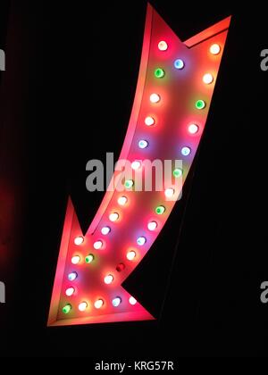 fairground carnival circus vegas style arrow pointing at night Stock Photo