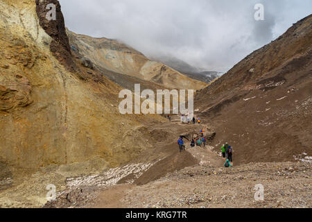 Tourists during the ascent to the active volcano Mutnovsky in Kamchatka. Stock Photo