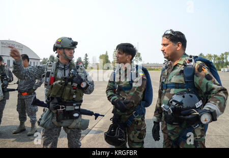 A Colombian Air Force member speaks to Pakistani Air Force members prior to a flight on a Colombian Casa 295 aircraft for a multinational personnel airdrop during Exercise Mobility Guardian at Joint Base Lewis-McChord, Wash., Aug. 6, 2017. The Colombian Air Force planned, led and executed the airdrop mission with participation from the French and Pakistani Air Forces and support from the U.S. Air Force. (U.S. Air Force Stock Photo
