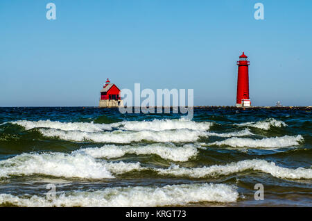 White-capped waves roll past the lighthouse and pier at Grand Haven, Michigan, on Lake Michigan Stock Photo