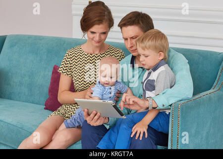 Happy family with computer tablet. Stock Photo