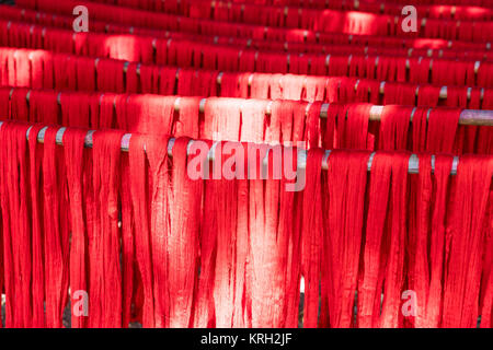 Colorful cotton yarn drying on a stick , in Mandalay near U bein brigde, Myanmar , Asia Stock Photo