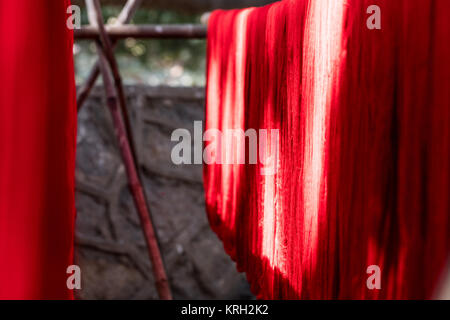 Colorful cotton yarn drying on a stick , in Mandalay near U bein brigde, Myanmar , Asia Stock Photo