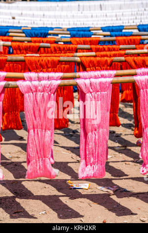 Colorful cotton yarn drying on a stick , in Mandalay near U bein brigde, Myanmar , Asia Stock Photo