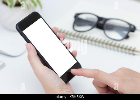 close up hand hold and finger touching on phone white screen Stock Photo