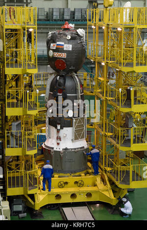 2014-09-18-11-42-24 At the Integration Facility at the Baikonur Cosmodrome in Kazakhstan, the Soyuz TMA-14M spacecraft stands ready for its encapsulation in the upper stage of the Soyuz booster rocket Sept. 18 that will propel it into orbit. The Soyuz will arrive at its launch pad on Sept. 23 for final pre-launch preparations. Expedition 41/42 Flight Engineer Barry Wilmore of NASA, Soyuz Commander Alexander Samokutyaev of the Russian Federal Space Agency (Roscosmos) and Flight Engineer Elena Serova of Roscosmos will launch aboard the Soyuz Sept. 26, Kazakh time, to begin a 5 ½ month mission on Stock Photo