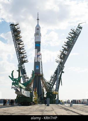 The gantry arms begin to close around the Soyuz TMA-14M spacecraft to secure the rocket at the launch pad Sept. 23, 2014 at the Baikonur Cosmodrome in Kazakhstan. Launch of the Soyuz rocket is scheduled for Sept. 26 and will carry Expedition 41 Soyuz Commander Alexander Samokutyaev of the Russian Federal Space Agency (Roscosmos), Flight Engineer Barry Wilmore of NASA, and Flight Engineer Elena Serova of Roscosmos into orbit to begin their five and a half month mission on the International Space Station. Photo Credit: (NASA/Joel Kowsky) Expedition 41 Rollout (201409230009HQ) Stock Photo