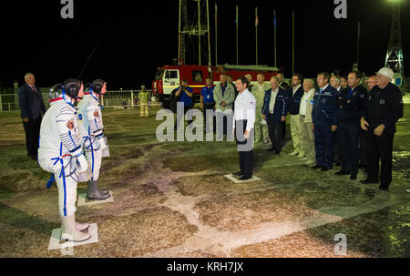 Oleg Ostapenko, General Director of the Russian Federal Space Agency (Roscosmos), center, greets Expedition 41 Soyuz Commander Alexander Samokutyaev of the Russian Federal Space Agency (Roscosmos), Flight Engineer Elena Serova of Roscosmos, and Flight Engineer Barry Wilmore of NASA at the launch pad on Thursday, Sept. 25, 2014 at the Baikonur Cosmodrome in Kazakhstan.  Samokutyaev, Serova, and Wilmore are scheduled to launch aboard their Soyuz TMA-14M spacecraft at 2:25 am Kazakhstan time to join Expedition 41 Commander Maxim Suraev of Roscosmos, Flight Engineer Reid Wiseman of NASA, and Fligh Stock Photo