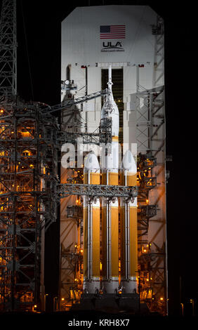 A United Launch Alliance Delta IV Heavy rocket with NASA’s Orion spacecraft mounted atop is seen as the Mobile Service Tower is rolled back, Wednesday, Dec. 3, 2014, at Cape Canaveral Air Force Station's Space Launch Complex 37, Florida. Orion is scheduled to make its first flight test on Dec. 4 with a morning launch atop the Delta IV Heavy. The spacecraft will orbit Earth twice, reaching an altitude of approximately 3,600 miles above Earth before landing in the Pacific Ocean. No one will be aboard Orion for this flight test, but the spacecraft is designed to allow us to journey to destination Stock Photo