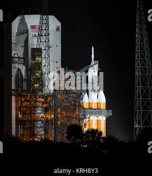 The United Launch Alliance Delta IV Heavy rocket with NASA’s Orion spacecraft mounted atop is seen early on Friday, Dec. 5, 2014, at Cape Canaveral Air Force Station's Space Launch Complex 37, Florida. Orion is scheduled to launch and make its first flight test later in the morning. The spacecraft will orbit Earth twice, reaching an altitude of approximately 3,600 miles above Earth before landing in the Pacific Ocean. No one will be aboard Orion for this flight test, but the spacecraft is designed to allow us to journey to destinations never before visited by humans, including an asteroid and  Stock Photo