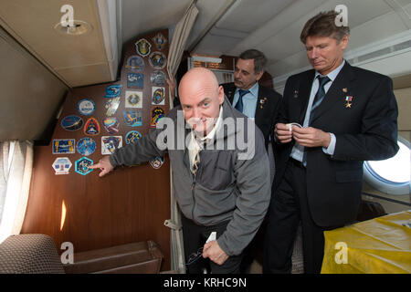 Expedition 43 NASA Astronaut Scott Kelly, points to his Expedition 43 crew mission patch after placing it on the  the Gagarin Cosmonaut Training Center (GCTC) aircraft during his flight from Star City, Russia, to Baikonur, Kazakhstan, with fellow crew members, Russian Cosmonauts Mikhail Kornienko, center, and Gennady Padalka of the Russian Federal Space Agency (Roscosmos), Saturday, March 14, 2015. The trio are preparing for launch to the International Space Station in their Soyuz TMA-16M spacecraft from the Baikonur Cosmodrome in Kazakhstan March 28, Kazakh time. As the one-year crew, Kelly a Stock Photo