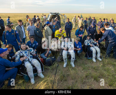 Expedition 43 commander Terry Virts of NASA, left, cosmonaut Anton Shkaplerov of the Russian Federal Space Agency (Roscosmos), center, and Italian astronaut Samantha Cristoforetti from European Space Agency (ESA) sit in chairs outside the Soyuz TMA-15M spacecraft just minutes after they landed in a remote area near the town of Zhezkazgan, Kazakhstan on Thursday, June 11, 2015. Virts, Shkaplerov, and Cristoforetti are returning after more than six months onboard the International Space Station where they served as members of the Expedition 42 and 43 crews. Photo Credit: (NASA/Bill Ingalls) Expe Stock Photo