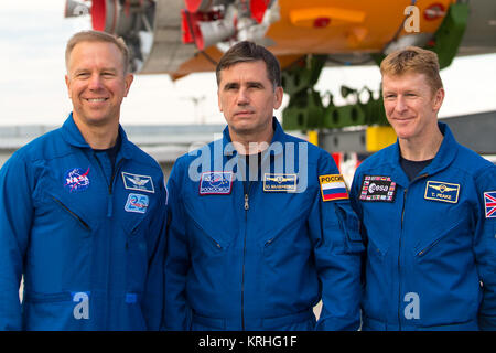 Expedition 44 backup crew members Timothy Kopra of NASA, left; Yuri Malenchenko of the Russian Federal Space Agency (Roscosmos), center; and Timothy Peake of the European Space Agency (ESA), right, pose for a photo as the Soyuz TMA-17M spacecraft is rolled to the launch pad by train on Monday, July 20, 2015 at the Baikonur Cosmodrome in Kazakhstan.  Launch of the Soyuz rocket is scheduled for July 23 and will carry Expedition 44 Soyuz Commander Oleg Kononenko of the Russian Federal Space Agency (Roscosmos), Flight Engineer Kjell Lindgren of NASA, and Flight Engineer Kimiya Yui of the Japan Aer Stock Photo