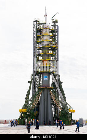 The gantry arms close around the Soyuz TMA-17M spacecraft to secure the rocket at the launch pad on Monday, July 20, 2015 at the Baikonur Cosmodrome in Kazakhstan.  Launch of the Soyuz rocket is scheduled for July 23 Baikonur time and will carry Expedition 44 Soyuz Commander Oleg Kononenko of the Russian Federal Space Agency (Roscosmos), Flight Engineer Kjell Lindgren of NASA, and Flight Engineer Kimiya Yui of the Japan Aerospace Exploration Agency (JAXA) into orbit to begin their five month mission on the International Space Station. Photo Credit: (NASA/Aubrey Gemignani) Expedition 44 Rollout Stock Photo