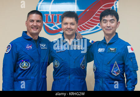 Expedition 44 crew members, Flight Engineer Kjell Lindgren of NASA, left; Soyuz Commander Oleg Kononenko of the Russian Federal Space Agency (Roscosmos), center; and Flight Engineer Kimiya Yui of the Japan Aerospace Exploration Agency (JAXA), right, pose for a photo at the conclusion of a press conference held at the Cosmonaut Hotel in Baikonur, Kazakhstan on Tuesday, July 21, 2015. The mission is set to launch July 23 from the Baikonur Cosmodrome. Photo Credit: (NASA/Aubrey Gemignani) Expedition 44 Press Conference (201507210026HQ) Stock Photo