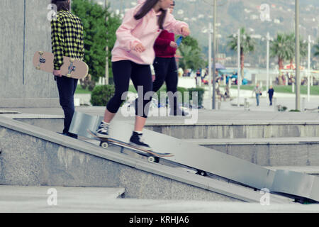 Teen girl skates on skateboard. Blur in Motion. Stock Photo