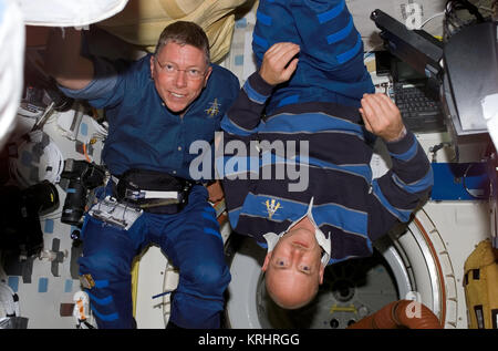 NASA Space Shuttle Discovery International Space Station STS-121 mission prime crew members American astronauts Michael Fossum (left) and Mark Kelly float in the Discovery middeck July 6, 2006 in Earth orbit. Stock Photo