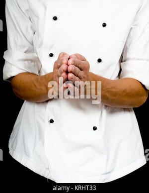 Professional chef with a hand gesture towards, wearing a chefs jacket Stock Photo