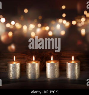 silver candles in front of a festive background Stock Photo