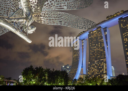 Futuristic scene with dragonfly sculpture by Eng Siak Loy and modern architecture at night - Gardens by the Bay, Marina Bay Sands Hotel, Singapore Stock Photo