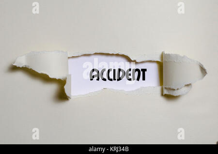 The word accident appearing behind torn paper Stock Photo