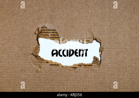 The word accident appearing behind torn paper Stock Photo