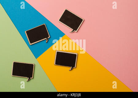 Square empty chalk board speech bubbles on colored papers Stock Photo