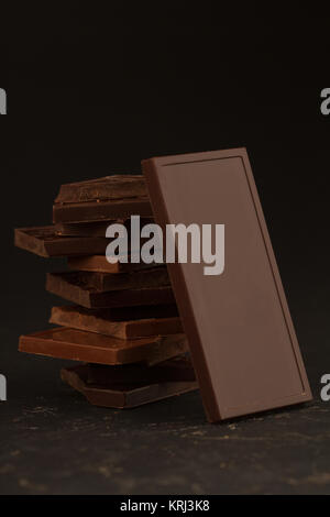 Square shaped chocolate pieces on dark background Stock Photo