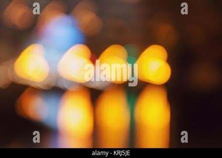 Bokeh in the shape of the heart - car lights are reflected on the asphalt. Stock Photo