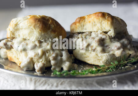 Biscuits with sausage gravy on a silver plate. Stock Photo