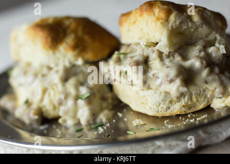 Biscuits with sausage gravy on a silver plate. Stock Photo