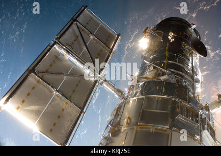 The Hubble Space Telescope in a picture snapped by a Servicing Mission 4 crewmember just after the Space Shuttle Atlantis captured Hubble with its robotic arm on May 13, 2009, beginning the mission to upgrade and repair the telescope.  The Hubble Space Telescope is a project of international cooperation between NASA and the European Space Agency. NASA's Goddard Space Flight Center manages the telescope. The Space Telescope Science Institute conducts Hubble science operations.  Goddard is responsible for HST project management, including mission and science operations, servicing missions, and a Stock Photo