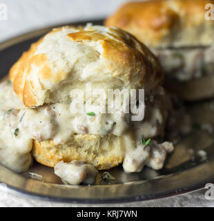 Biscuits with sausage gravy on a silver plate. Stock Photo