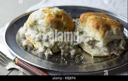 Biscuits with sausage gravy on a silver plate. Stock Photo