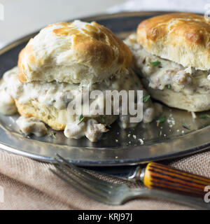 Biscuits with sausage gravy on a silver plate. Stock Photo