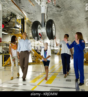 President Barack Obama, First Lady Michelle Obama, daughters Malia, left, Sasha, and Astronaut Janet Kavandi walk under the landing gear from beneath the nose of space shuttle Atlantis as they visit Kennedy Space Center in Cape Canaveral, Fla., Friday, April 29, 2011. Photo Credit: (NASA/Bill Ingalls) STS-135 Obama family inspects space shuttle Atlantis Stock Photo