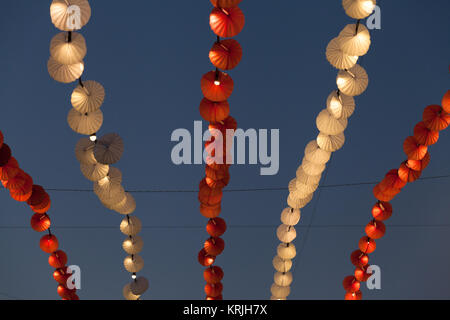 Lights and decoration in amusement park over evening sky Stock Photo