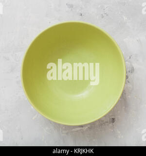 above view of green bowl on concrete plate Stock Photo
