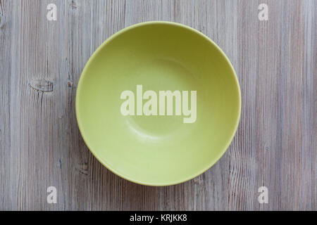 above view of green bowl on gray brown table Stock Photo