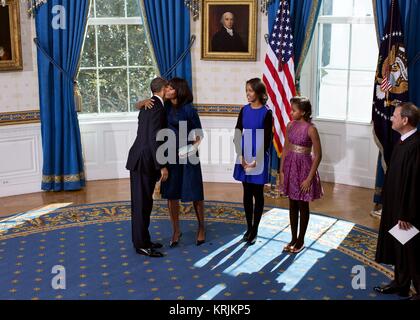 U.S. President Barack Obama hugs U.S. First Lady Michelle Obama after his official swearing-in ceremony on Inauguration Day at the White House Blue Room January 20, 2013 in Washington, DC. Stock Photo