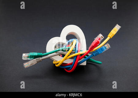 Online love and social networking concept. Network cables with heart shape Stock Photo
