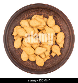 Goldfish Crackers in brown plate. Isolated on white background. Stock Photo