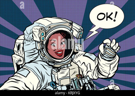 OK gesture woman astronaut in a spacesuit Stock Photo