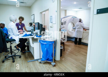 Doctor and technician talking near scanner Stock Photo