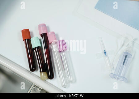 Test tubes with caps on table near syringe Stock Photo