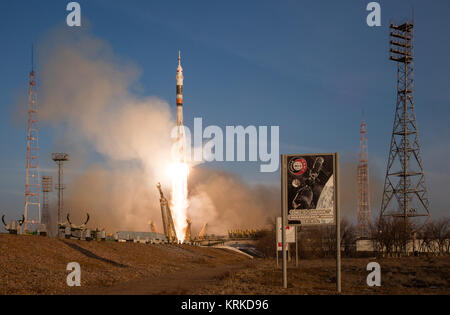 With a sign commemorating the 1975 Apollo-Soyuz mission in the foreground, the Soyuz TMA-19M spacecraft launched from the Baikonur Cosmodrome in Kazakhstan, Tuesday, Dec. 15, 2015, sending Expedition 46 Flight Engineer Tim Kopra of NASA, Soyuz Commander Yuri Malenchenko of the Russian Federal Space Agency (Roscosmos) and Flight Engineer Tim Peake of ESA (European Space Agency) to orbit for the start of six-month mission on the International Space Station. Photo Credit: (NASA/Joel Kowsky) Expedition 46 Launch (NHQ201512150033) Stock Photo