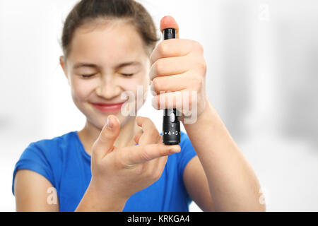 diabetic girl measuring sugar level with a glucometer Stock Photo