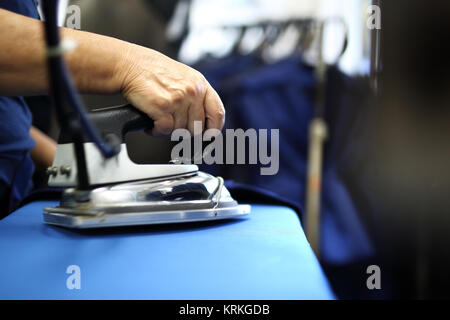 clothing industry. ironing steam. presser in sewing clothes pressed. Stock Photo